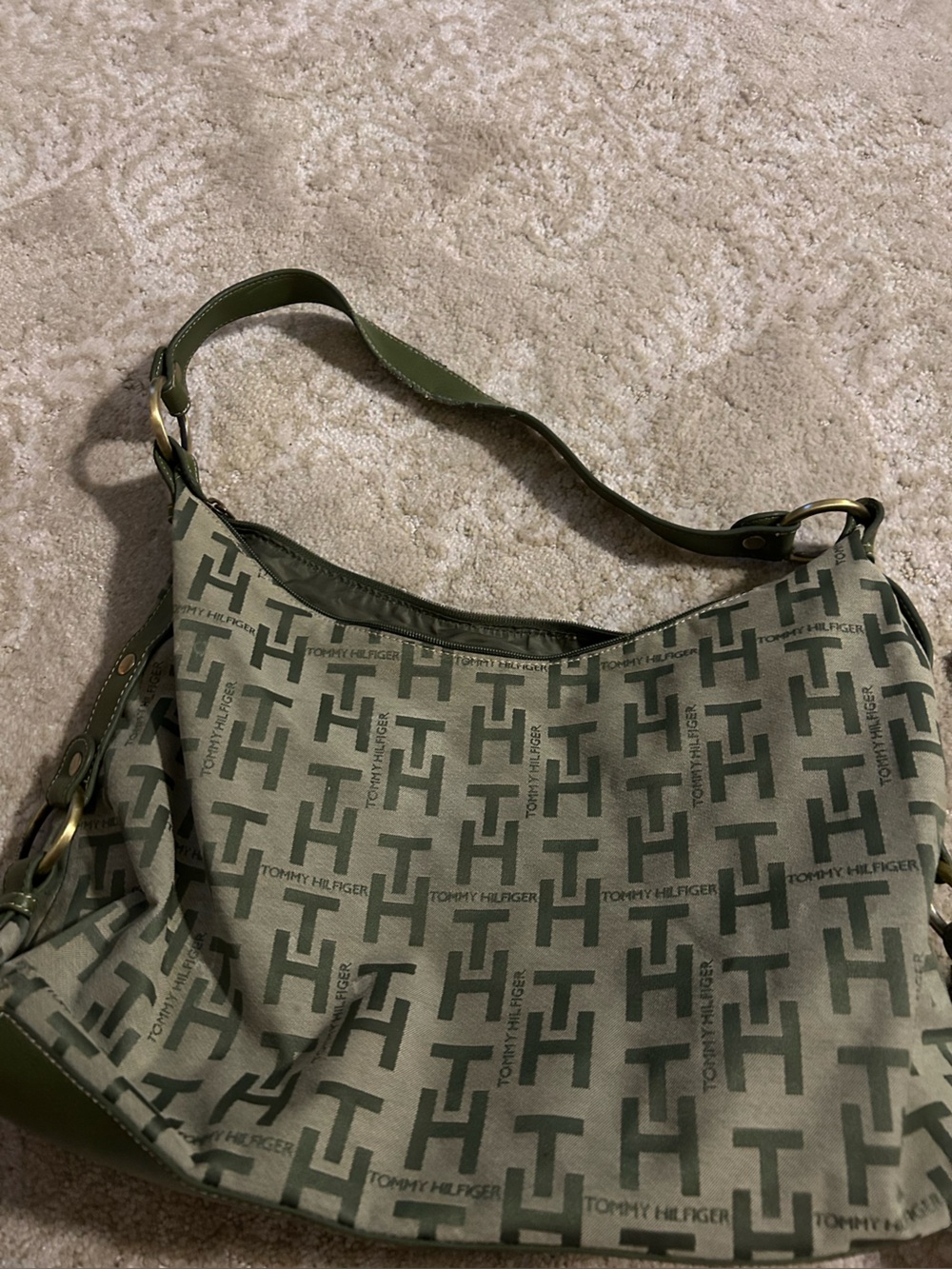 Roomy shoulder/hand bag. Tommy Hilfiger name branded on body of purse.